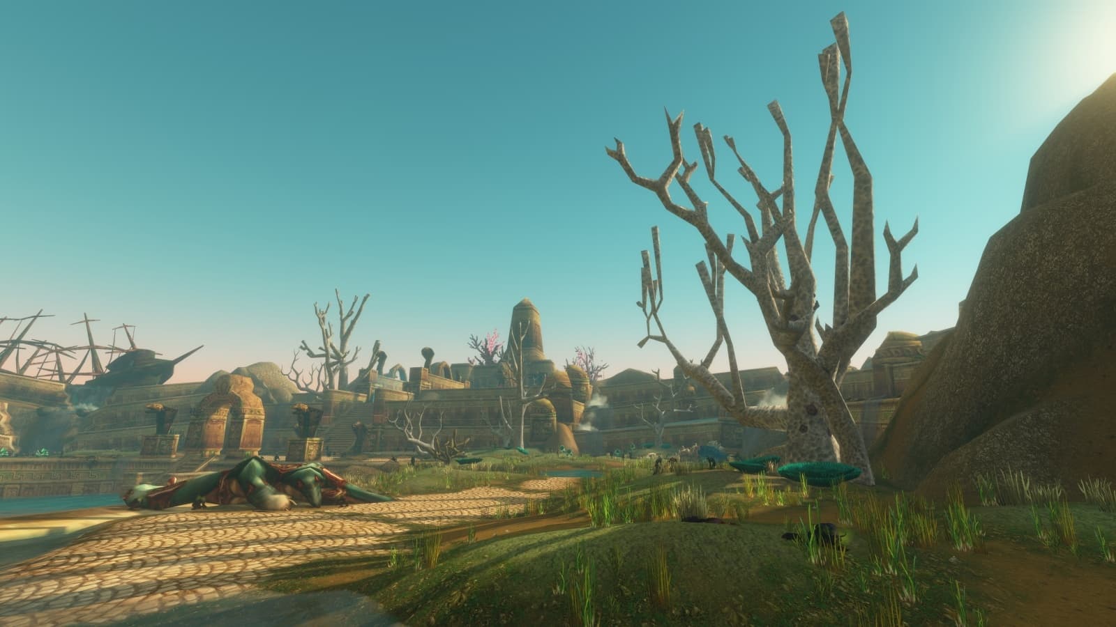 Une cité de pierre en ruine au bord de l'eau, avec des arbres secs et une épave de navire, sous un ciel dégagé